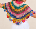 Flower Halo artistic crochet cape top, back view on a mature blonde model