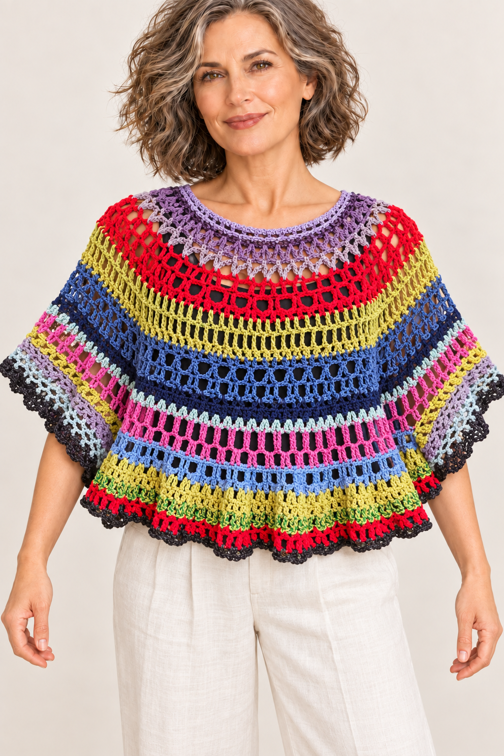 Colour Orbit handmade multicolour crochet XL cape top on a blonde model, front view