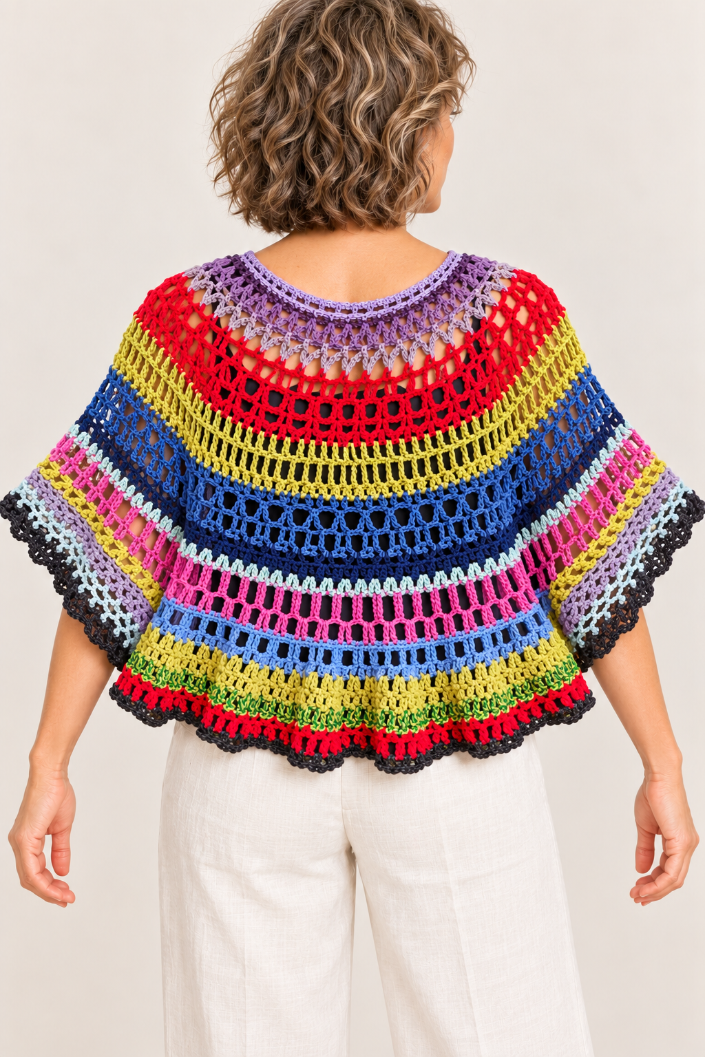 Colour Orbit handmade multicolour crochet XL cape top on a blonde model, back view