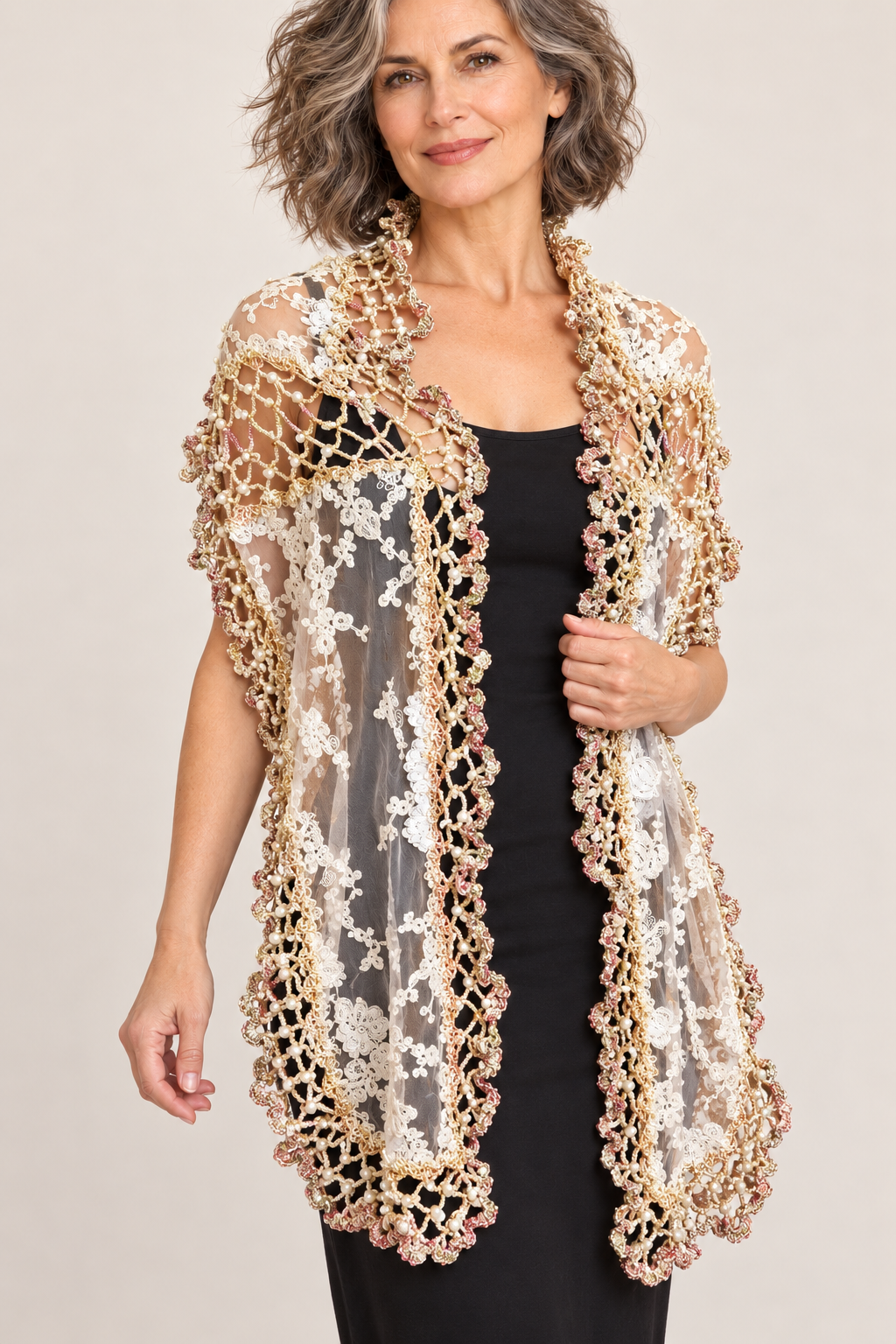 Long ecru lace shawl with pearl crochet edging worn by a woman – front view