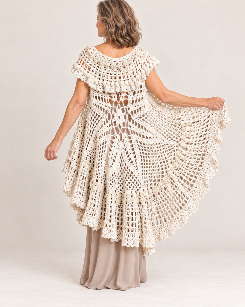 Cream crochet circular cape vest worn by a blonde woman – back view
