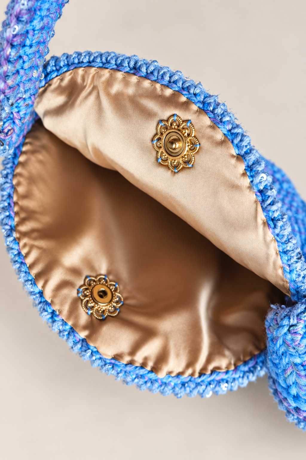 Interior of the Dandelion Dreams handbag with champagne satin lining and magnetic clasp